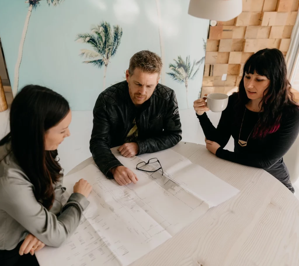 Little Star design team meeting at table to review design plans